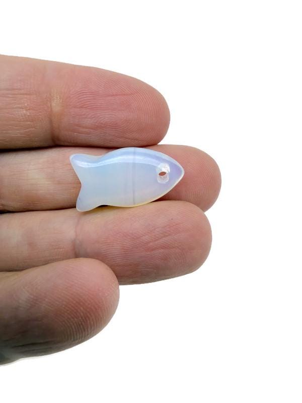Opalite fish-shaped crystal pendant with healing properties, featuring a silver-tone fish charm for jewelry embellishment.