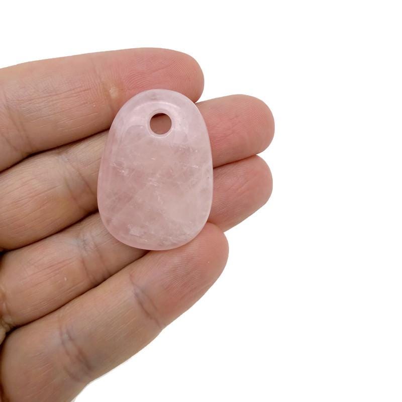 Rose quartz oval crystal pendant by GemstoneGO, natural stone jewelry making bead with smooth polished surface and elegant oval shape.