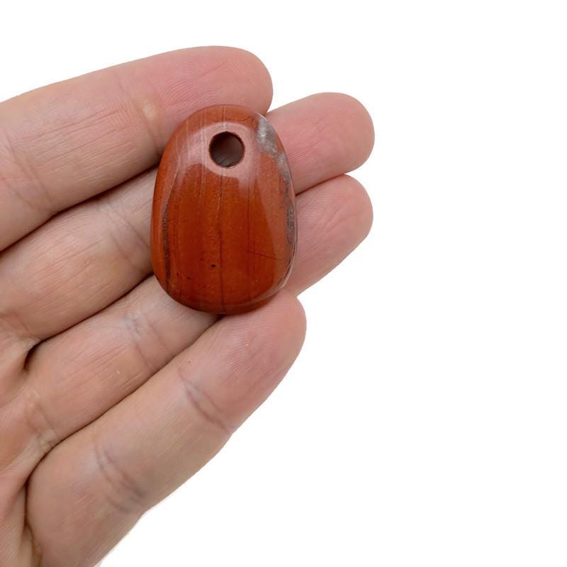 Red Jasper oval crystal pendant from GemstoneGO, showcasing a polished natural stone bead for jewelry making.