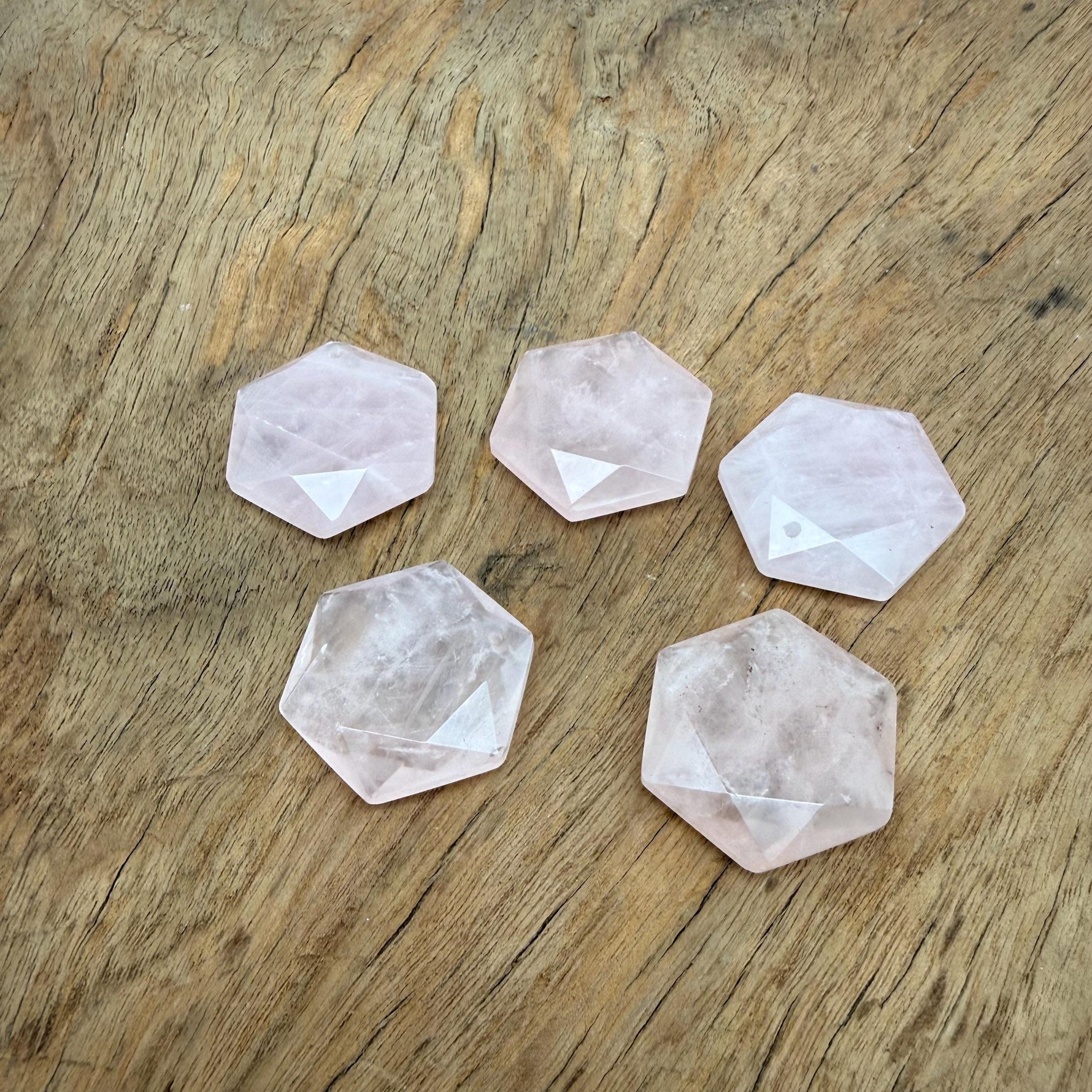 Faceted rose quartz hexagon crystal pendant necklace with a polished stone bead, showcasing a delicate, natural gemstone necklace.