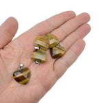 Faceted Tiger Eye heart crystal pendant with natural gemstone charm, showcasing warm amber tones and polished surface.
