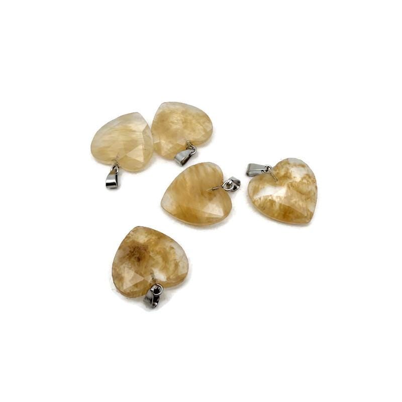 Yellow smelting quartz faceted heart crystal pendant from GemstoneGO, showcasing a natural crystal charm with a polished, faceted surface.