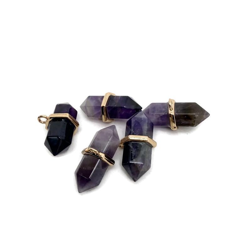 Natural amethyst double terminated crystal pendant from GemstoneGO, showcasing a pointed purple gemstone on a plain background.