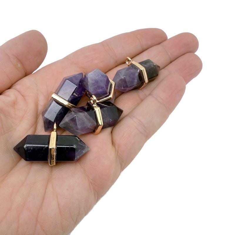 Natural amethyst double terminated crystal pendant from GemstoneGO featuring a pointed purple gemstone.
