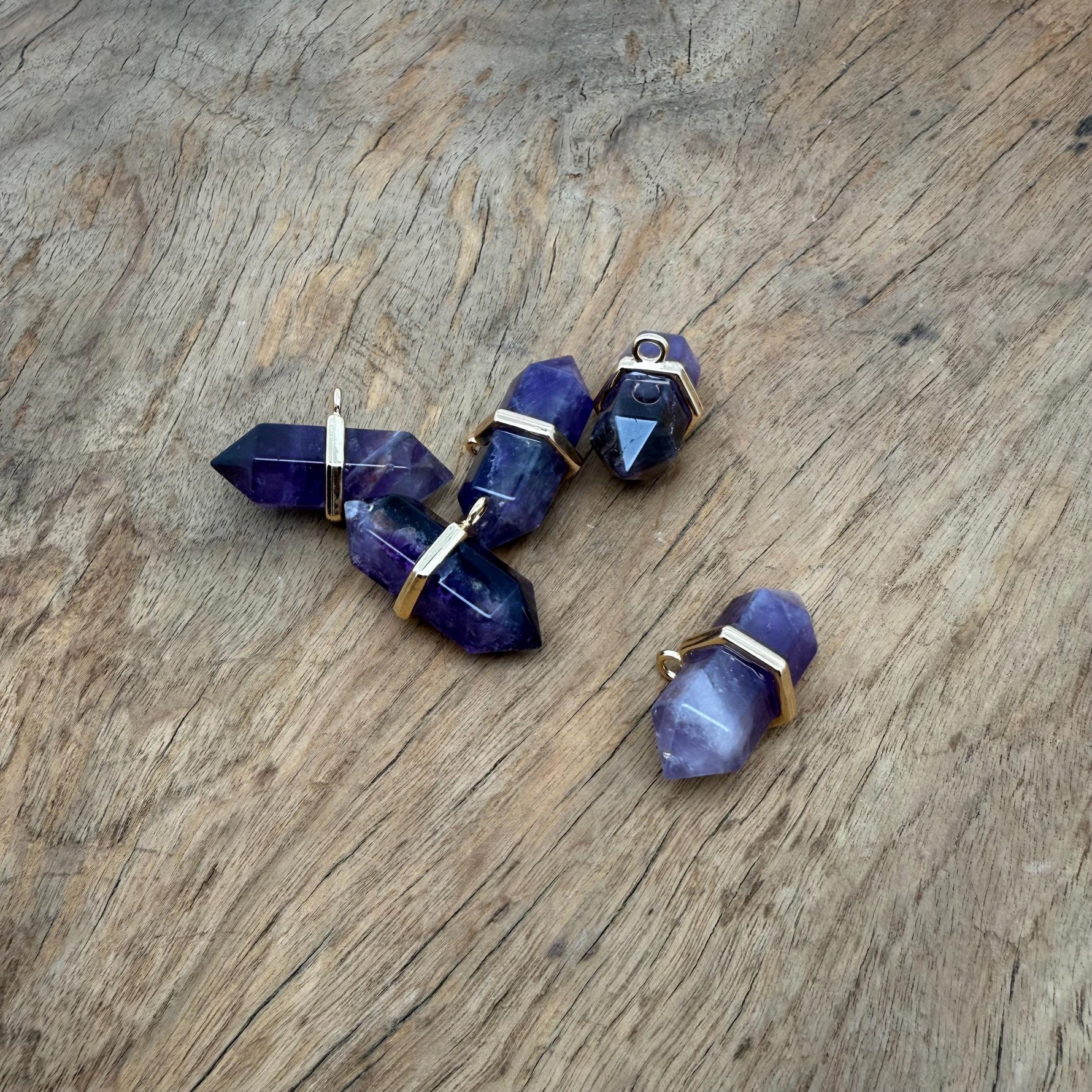 Amethyst double terminated crystal pendant from GemstoneGO featuring a natural purple gemstone point, polished and ready to wear.